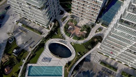 Ascend-top-down-showing-giant-skyscrapers-and-traffic-on-road-in-Puerto-Madero-District-of-Buenos-Aires