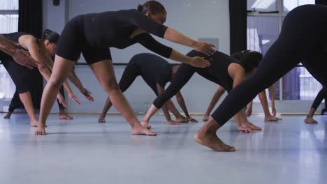 Multi-ethnic-group-of-fit-male-and-female-modern-dancers-practicing-a-dance-routine-