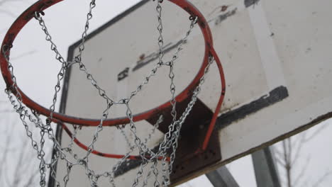 basketball court close up of basketball hoop, moving in on the iron net