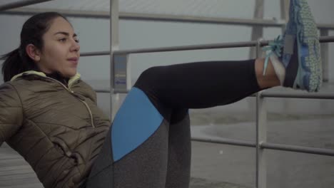 Slow-motion-shot-of-concentrated-hindu-brunette-woman-training-on-jetty