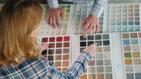 a group of designers are working on a color solution using a catalogue of samples 1