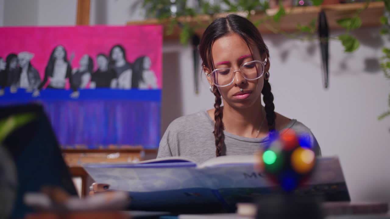 Young art student reading a book