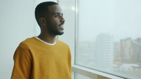 man looking out a window
