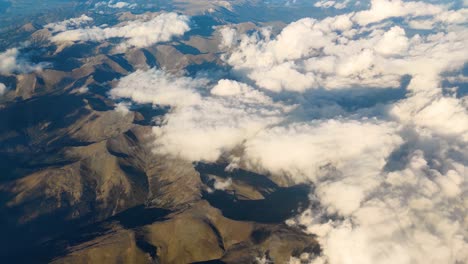 breathtaking mountain range covered by cumulus clouds pov