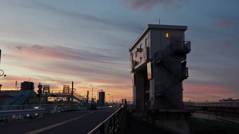 a shot of the sumida sluice gate building on the sumida river against a beautiful dusk sky