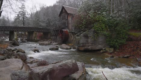 grist mill in west virginia with river flowing