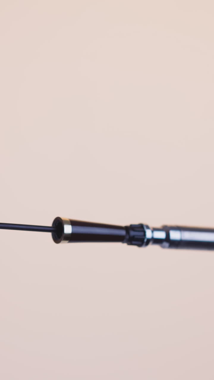 Luxury black mascara wand to increase volume of eyelashes on beige background. Presentation of high quality cosmetic product for makeup closeup