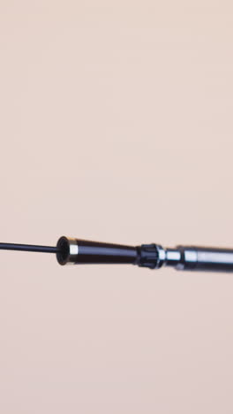 luxury black mascara wand to increase volume of eyelashes on beige background. presentation of high quality cosmetic product for makeup closeup