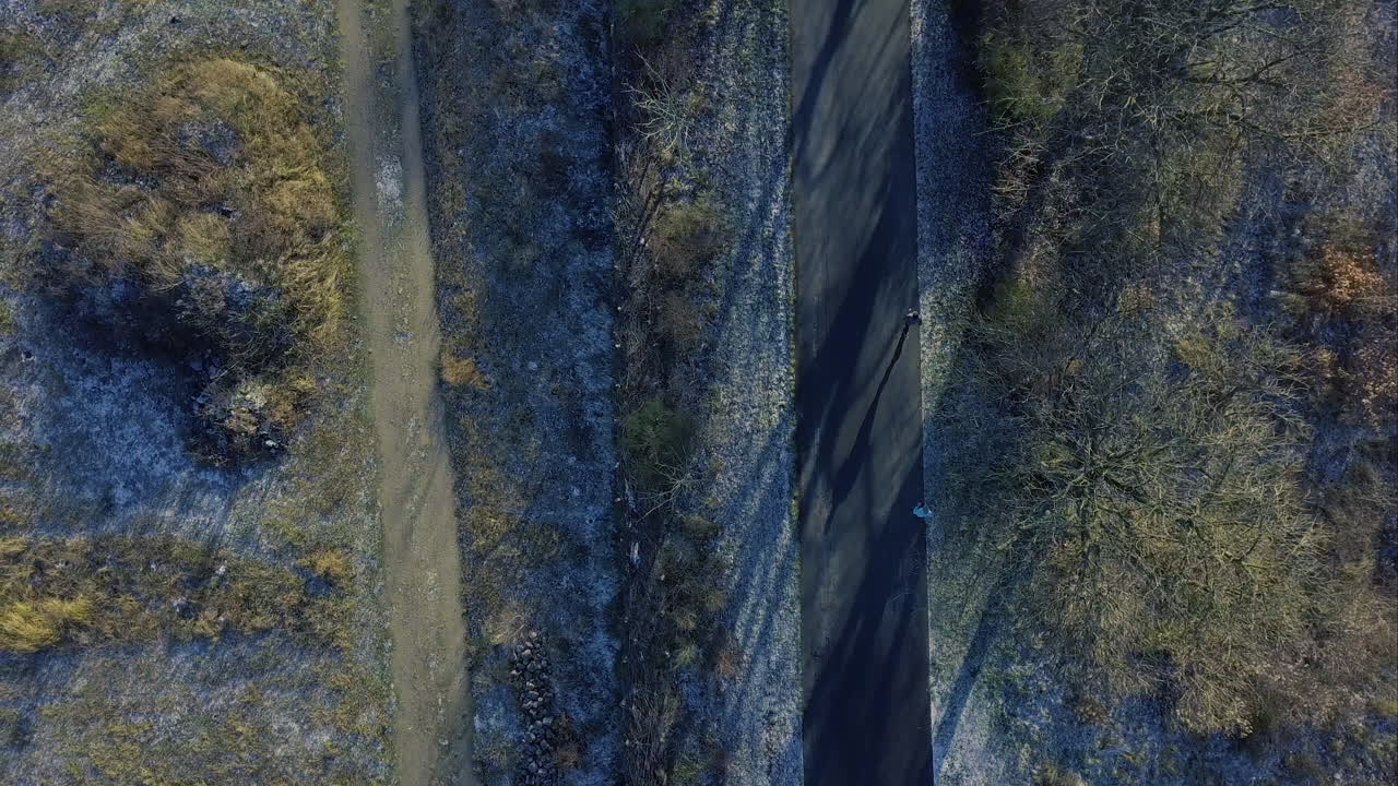 Drone flying above a runner in Winter
