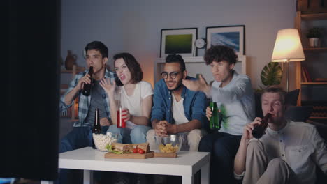 friends watching tv and celebrating