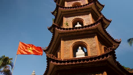 with the vietnamese flag flying proudly in the wind, tran quoc pagoda temple