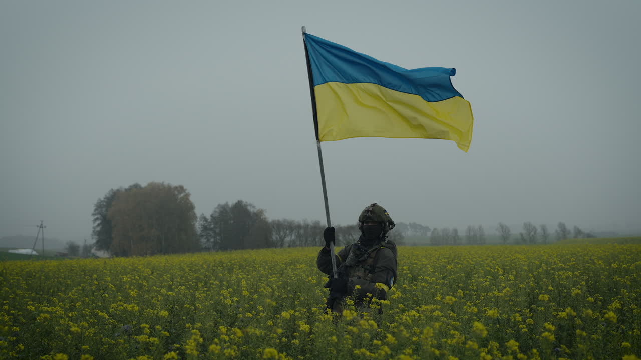 Ukrainian Soldier with Flag in a Field