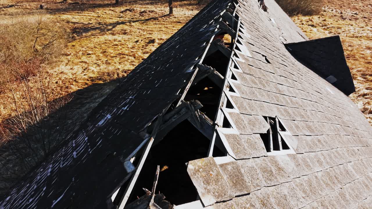 Crumbling Soviet era farm rooftop, slow motion, early spring in rural Latvia, 4K