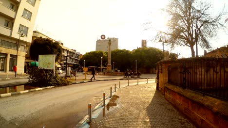 ataturk square with old venetian colonm cars and passers