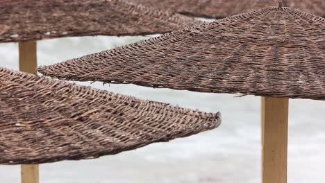 rattan roofed sunshades in tropical beach resort