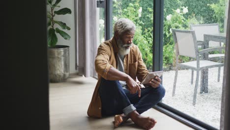 Video-of-african-american-senior-man-using-smartphone