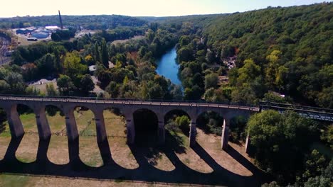 drone flying over a bridge in a park, quite large angle