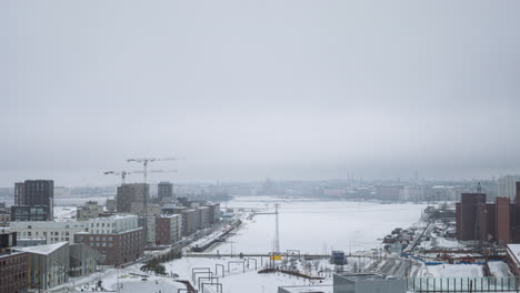 Time-lapse-of-thick-winter-mist-covering-snowy-Helsinki-from-Kalasatama