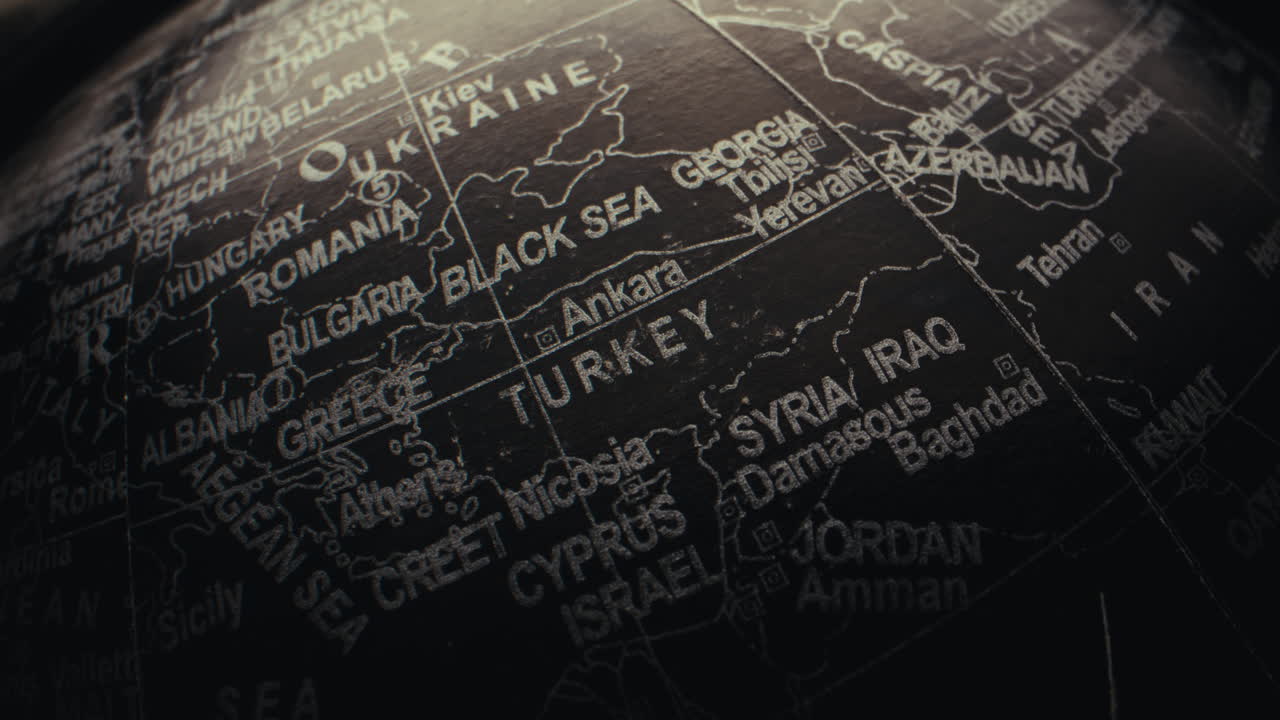 Close-up of a black globe with highlighted countries