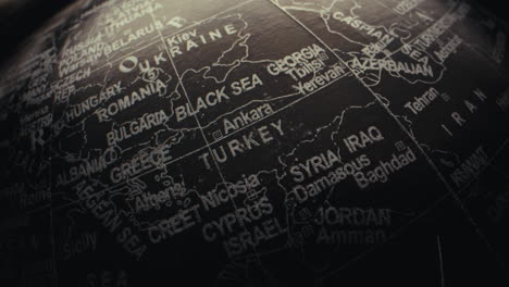 close-up of a black globe with highlighted countries