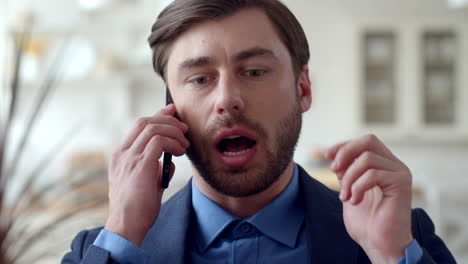 Focused-business-man-getting-new-idea-during-phone-call-at-remote-office