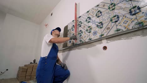 installing ceramic wall tiles - measuring and cutting the pieces. construction, renovation, repair apartment. cuts tile. tile cutting