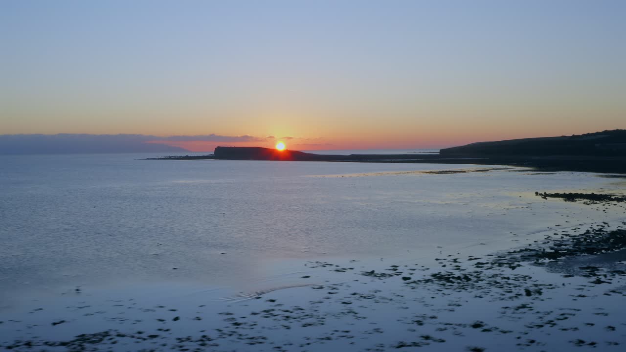 Aerial pan over the stunning Galway Bay coastline at sunset, with vibrant colors and silhouettes