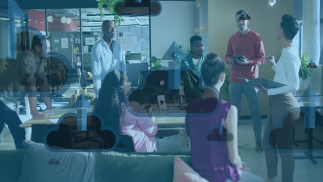 animation of clouds with arrows icons over diverse colleagues talking in office