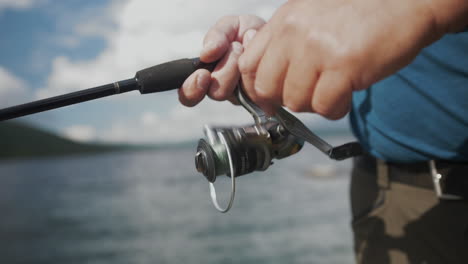 close up of a man spinning fishing rod