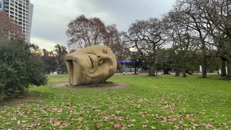 statue of a big head in an empty park in buenos aires