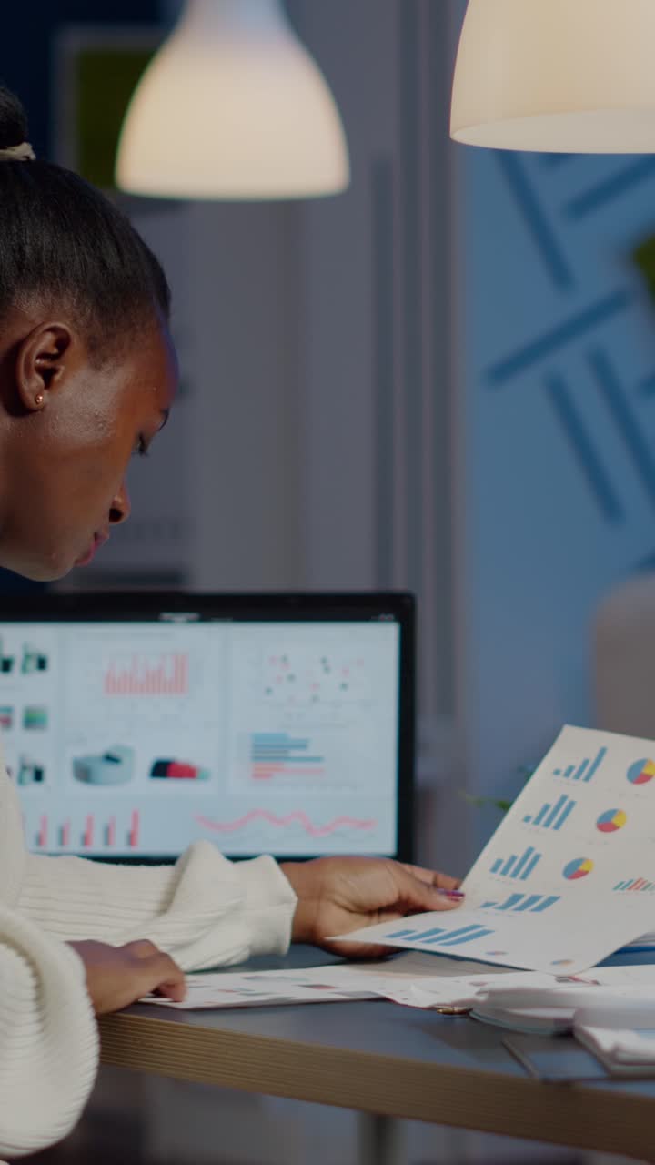 Vertical video African business woman holding documents with graphics