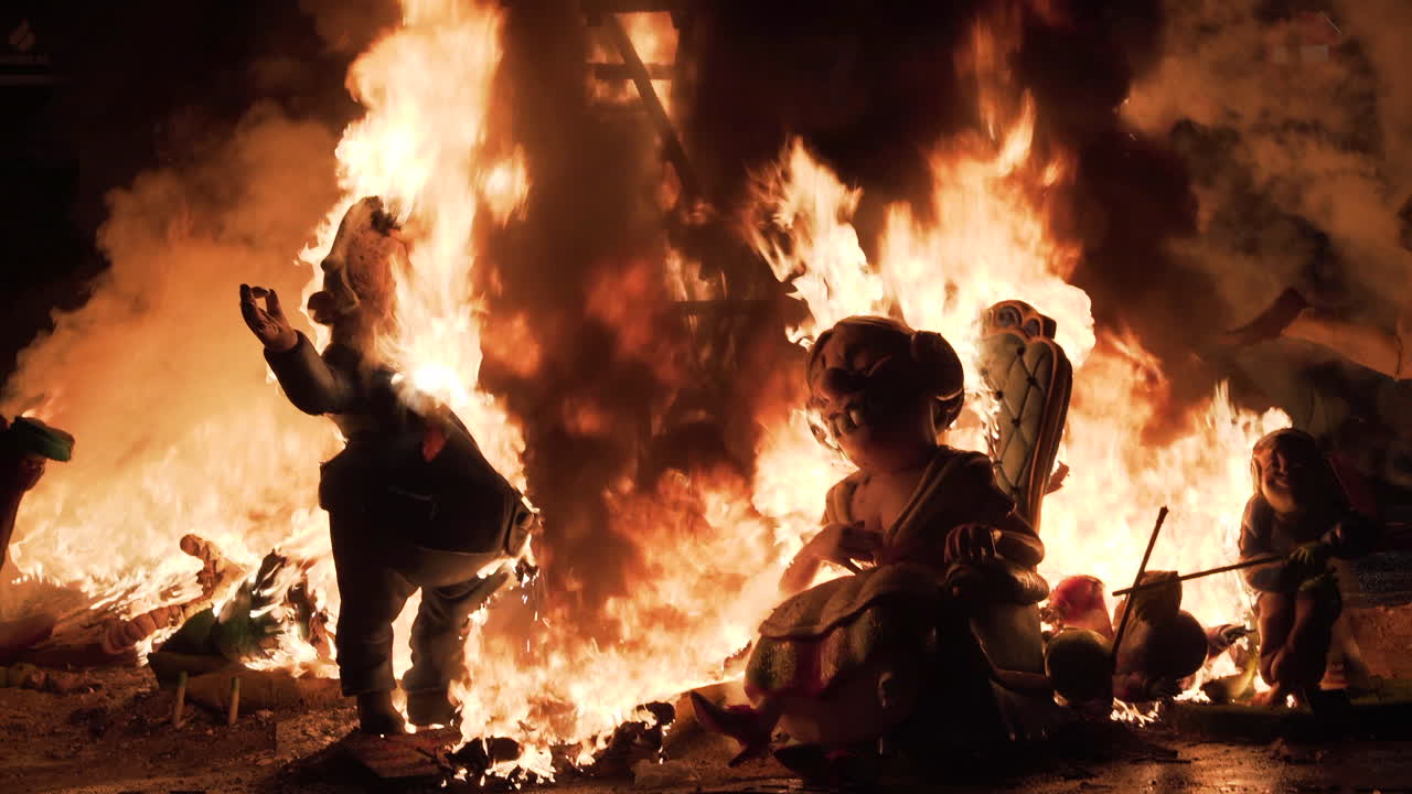 Burning Figures in a Large Bonfire at Night