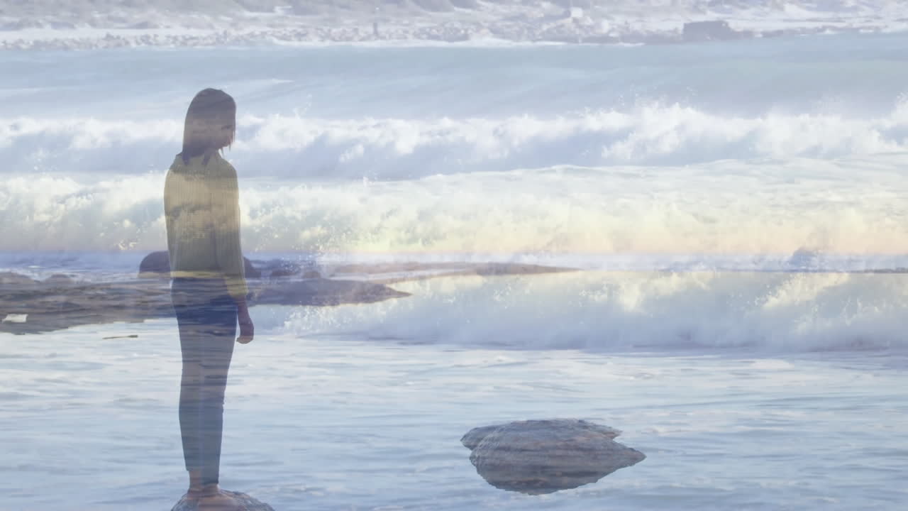 By ocean, person contemplating nature's beauty with waves crashing around them