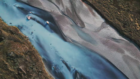 fast and ascending aerial view over colorful river in mountains