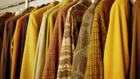 a close-up shot of a rack of colorful vintage clothing