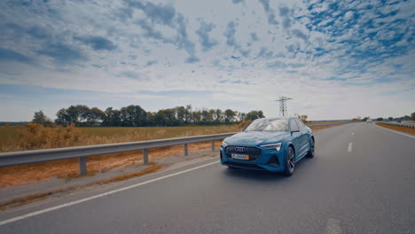 audi e tron profile view. audi e tron, a fully electric car on highway