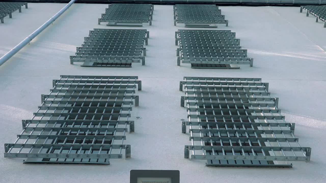 A secured arched window with metal bars casts dramatic shadows on a pale textured wall, evoking themes of security, confinement, or protection.