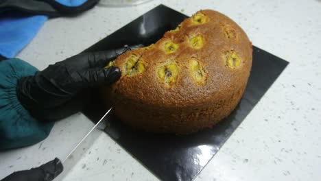 freshly baked cakes are carefully cut to get the same cut size. it is cut using a long cutting knife