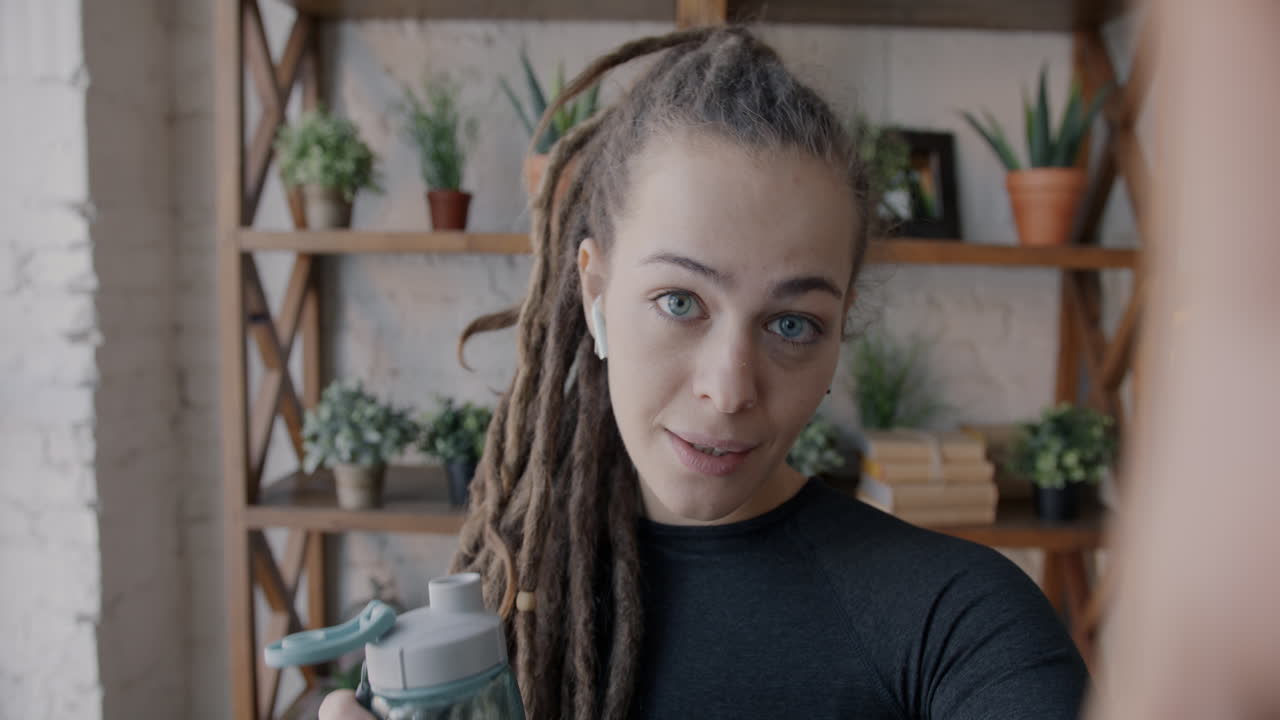 Woman Taking a Selfie While Drinking Water