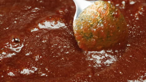 making meatballs in tomato sauce