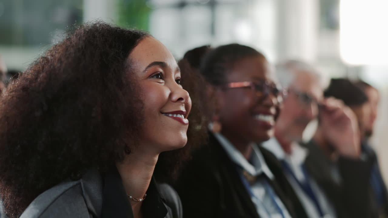 A group of diverse people attend a business meeting or conference.