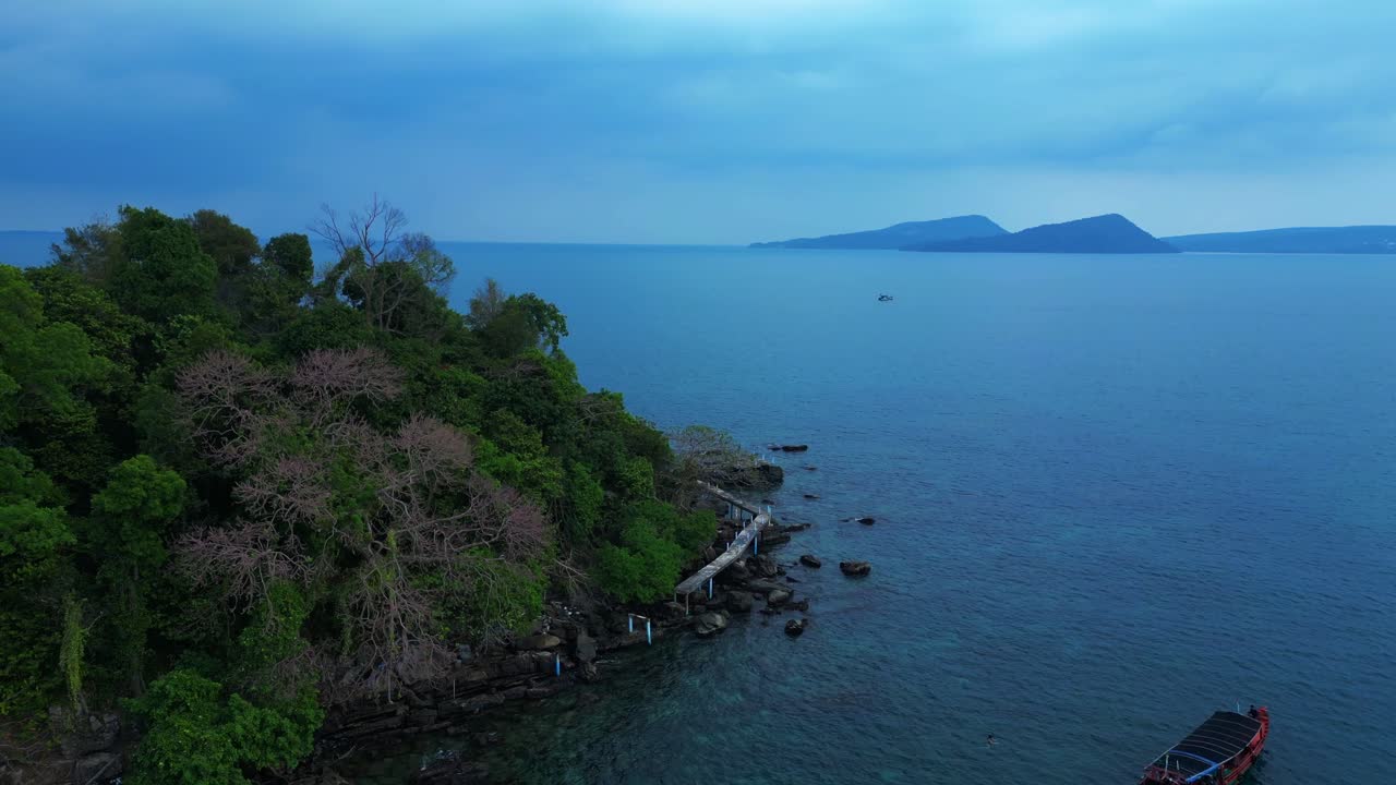 Tourist boats surrounding tropical Koh Toch Island near Sihanoukville, Cambodia. Nice aerial view flight descending drone