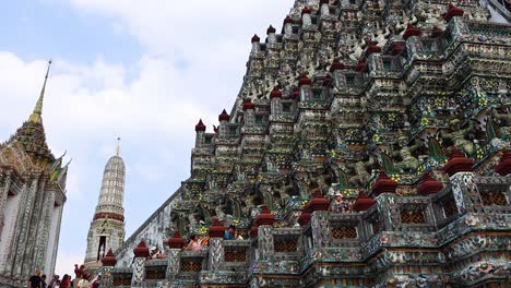 a 12-second video captures the intricate details of wat arun temple under clear skies in bangkok, thailand