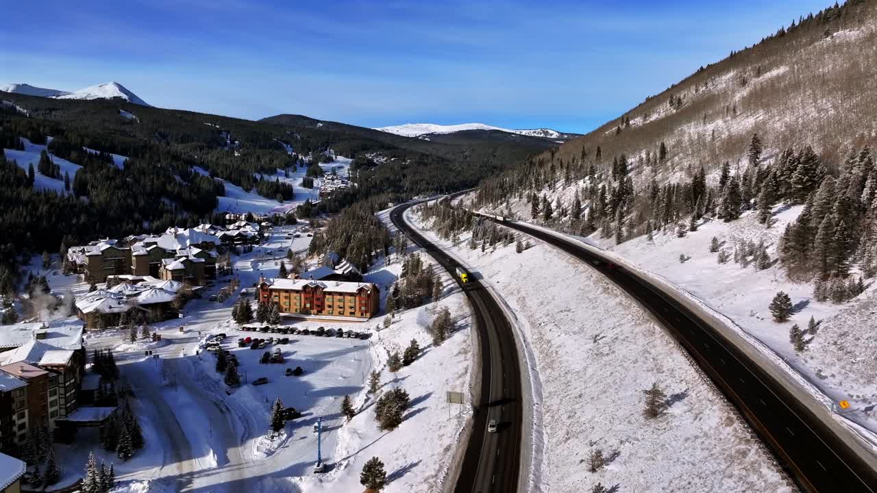 Morning sunrise winter solstice Copper Mountain aerial drone Colorado i70 cars traffic Vail Pass Ikon Alterra snowboarding snow ski riding trails December trees forward slowly