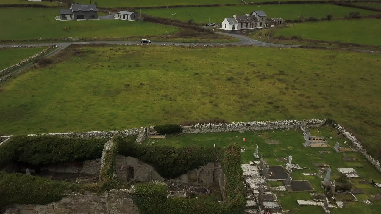Flying over Irish ruins and rolling green countryside on grey day4K 29fps
