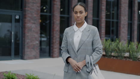 businesswoman in front of a modern building