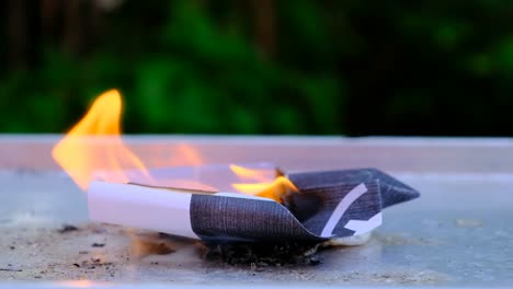 a fire is burning on a paper plane