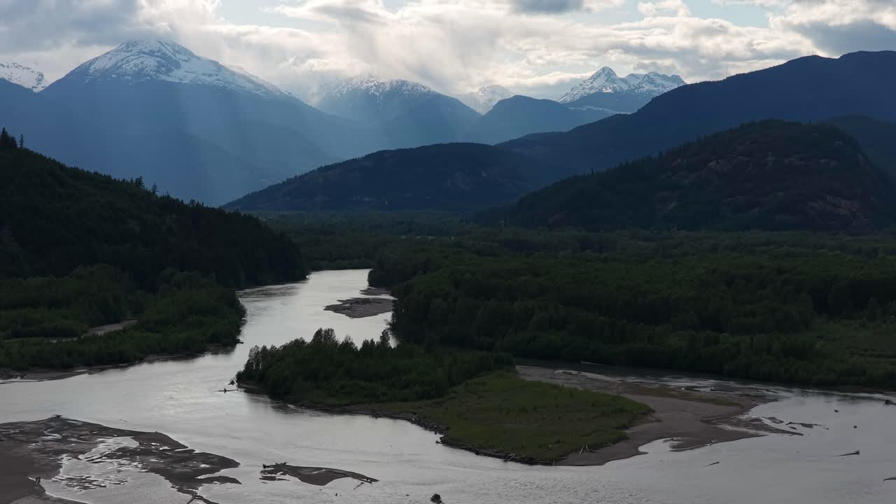 Scenic river flowing through mountains in BC, Canada. Calm and peaceful nature.