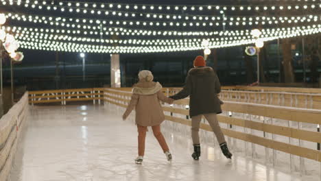 couple ice skating at night