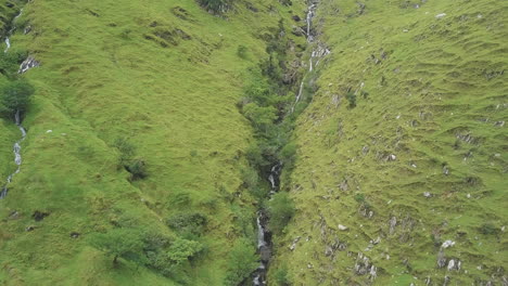 colorful 4k video of falling water among emerald greens of wild irish nature in kerry mountains